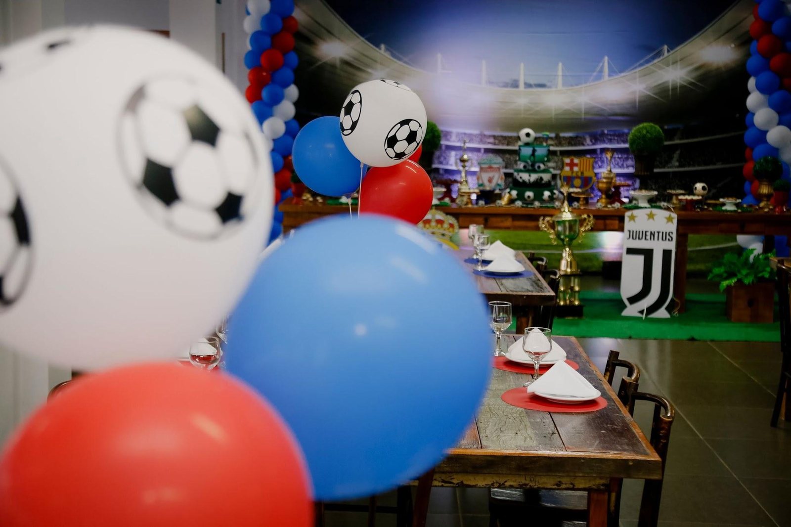 Soccer themed birthday party setup with balloons and table settings
